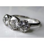 A platinum and diamond three stone ring, the central brilliant cut stone of approximately 1.5ct, 7.