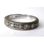 An 18ct with gold and diamond half eternity ring, the rubover setting with seven diamonds, 5.8g,