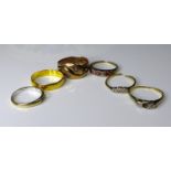 A group of six gold gold rings, comprising a 22ct gold wedding band size S, 3.6g, three 18ct gold
