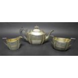 A Victorian silver three piece tea set, with bright cut decoration and reeded bases,