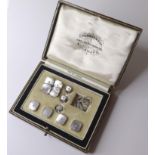 A set of gentleman's 9ct white gold dress studs, with mother of pearl and seed pearls to the centre,