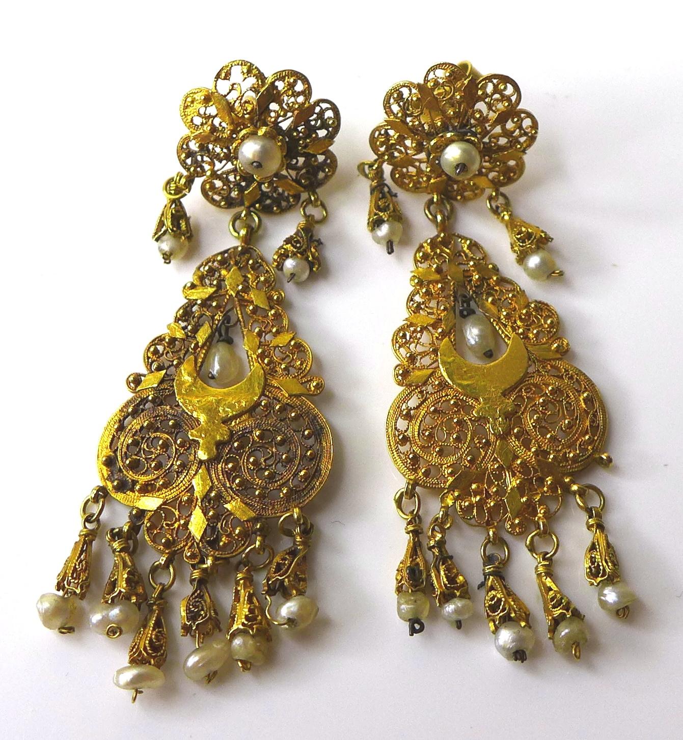 A pair of 1930s Indian 9ct gold earrings with seed pearl drops, very fine pierced decoration, each