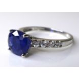 A 14ct white gold and sapphire solitaire dress ring, the cushion cut deep cornflower blue stone of