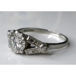 An Art Deco diamond and platinum ring, the central brilliant cut diamond of approximately 1.4ct,