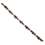 A 9ct gold and amethyst bracelet, formed of seven links each with an oval cut stone in four claw