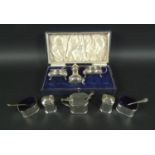 Two silver cruet sets, comprising a three piece George VI silver cruet set, with lidded mustard,