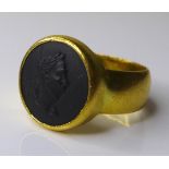 A gentleman's 22ct gold signet ring, set with a black basalt cameo, AC Co, London, 1945, size M, 8.
