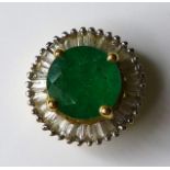 An 18ct gold emerald and diamond pendant, the round cut emerald of 6mm diameter surrounded by