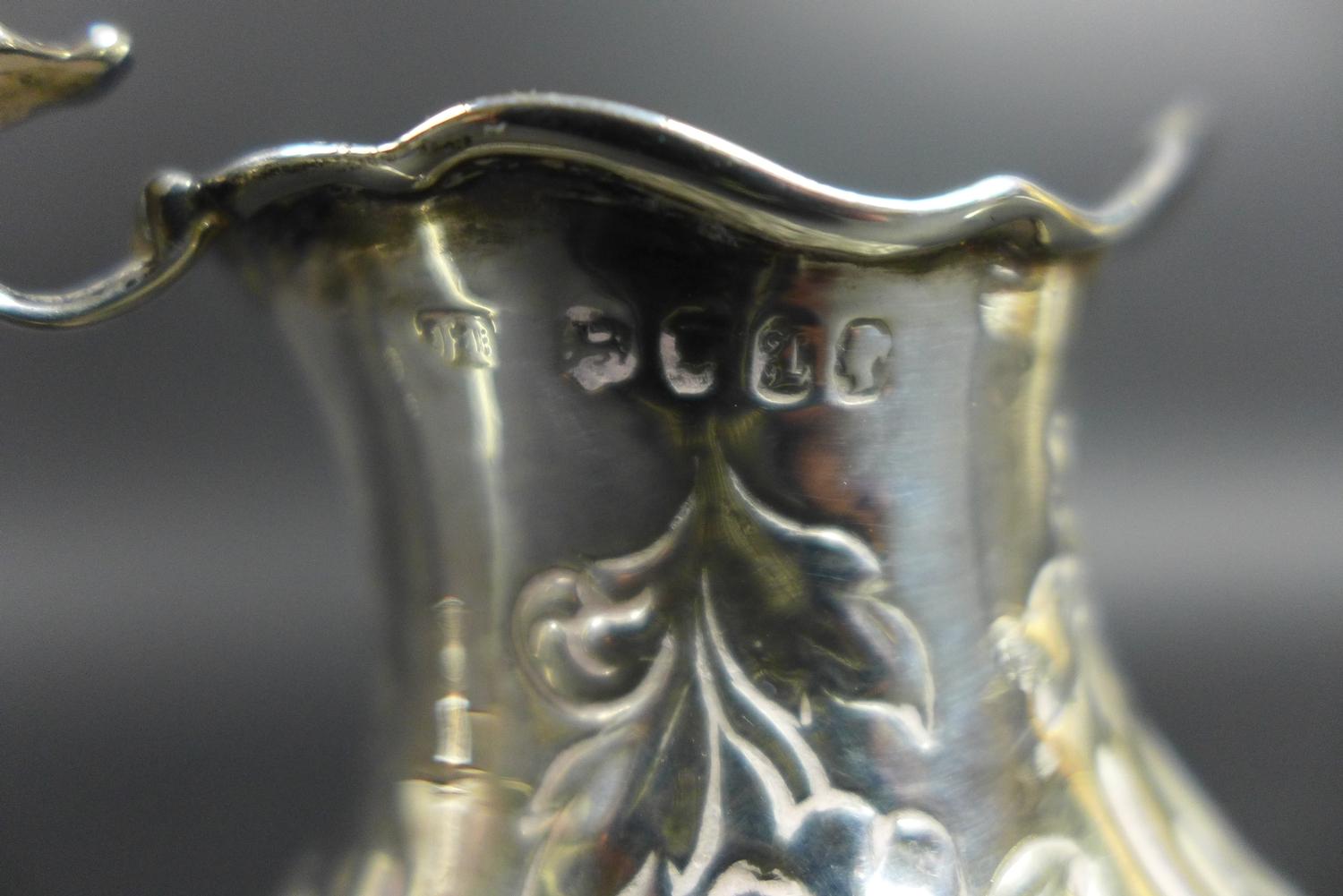 A group of five silver items, comprising a Victorian milk jug with repousse decoration and C - Image 3 of 14