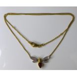 An 18ct gold, tourmaline and diamond bee pendant necklace, the thorax set with a pear shaped