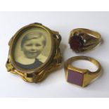 Two 9ct gold gentlemans' rings, one claw set with an oval cut garnet, size P, the other with a