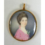 A Georgian gold cased pendant oval portrait miniature, half length, depicting a Georgian lady with