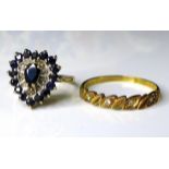 A 9ct gold sapphire cluster ring, the pear cut central sapphire 6mm long, surrounded by five