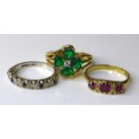 Three 9ct gold rings, comprising an early 20th century three stone ruby ring, size M, a white