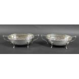 A pair of silver George V twin handled oval form planished bowls, with presentation inscription