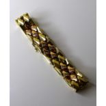 A 9ct bicoloured gold bracelet, composed of yellow and rose gold lozenge shaped panels, 18.5cm long,