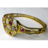 A Victorian 15ct gold ruby and diamond bangle with crescent moon and five pointed star design,