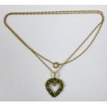 A 9ct gold, emerald and diamond heart shaped pendant, 2cm long, on a 9ct gold chain, 51cm long, 2.