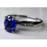 An 18ct white gold, sapphire and diamond dress ring, the deep cornflower blue sapphire of