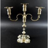 An Elizabeth II silver candelabrum, in the Georgian style, twin scrolling branches issuing from