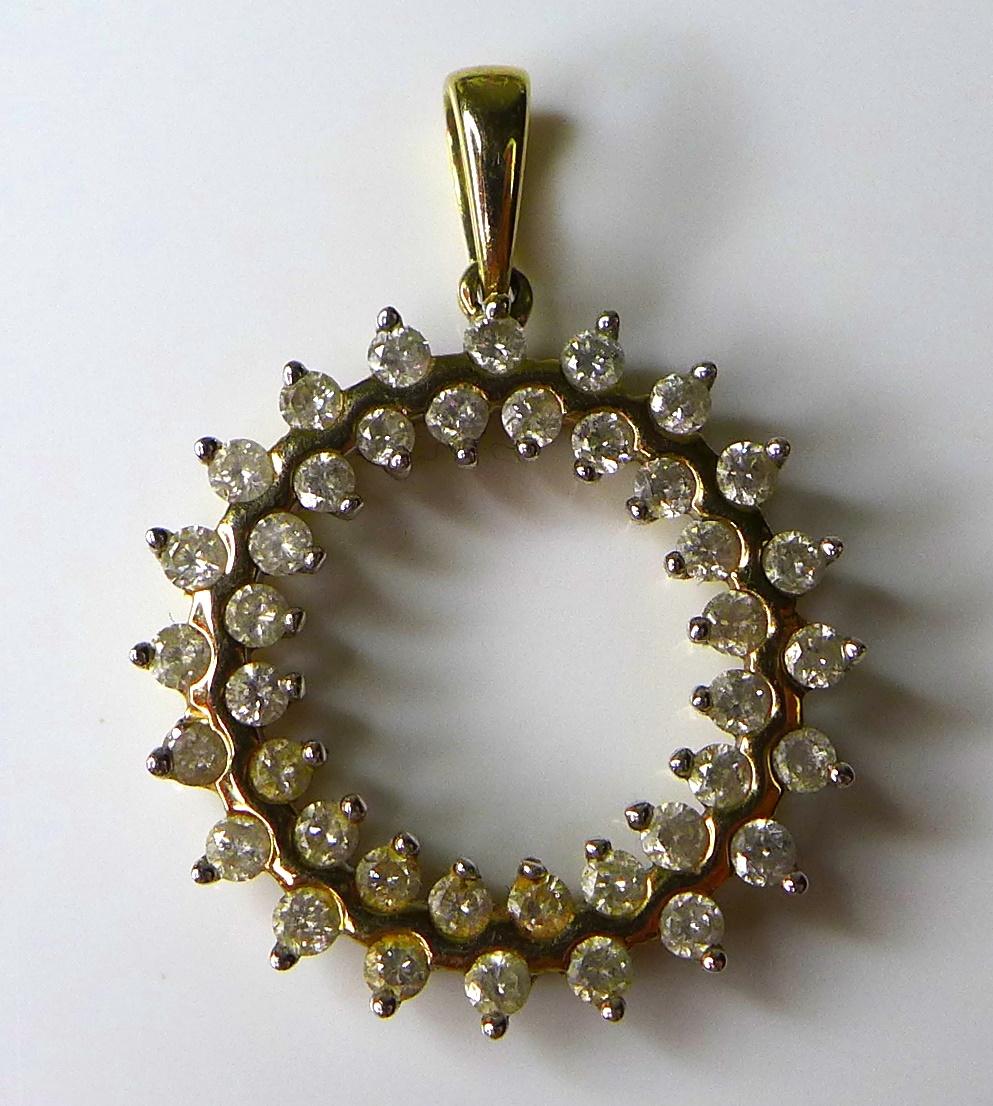 A 9ct gold and diamond circular pendant, with 40 round brilliant cut diamonds totalling