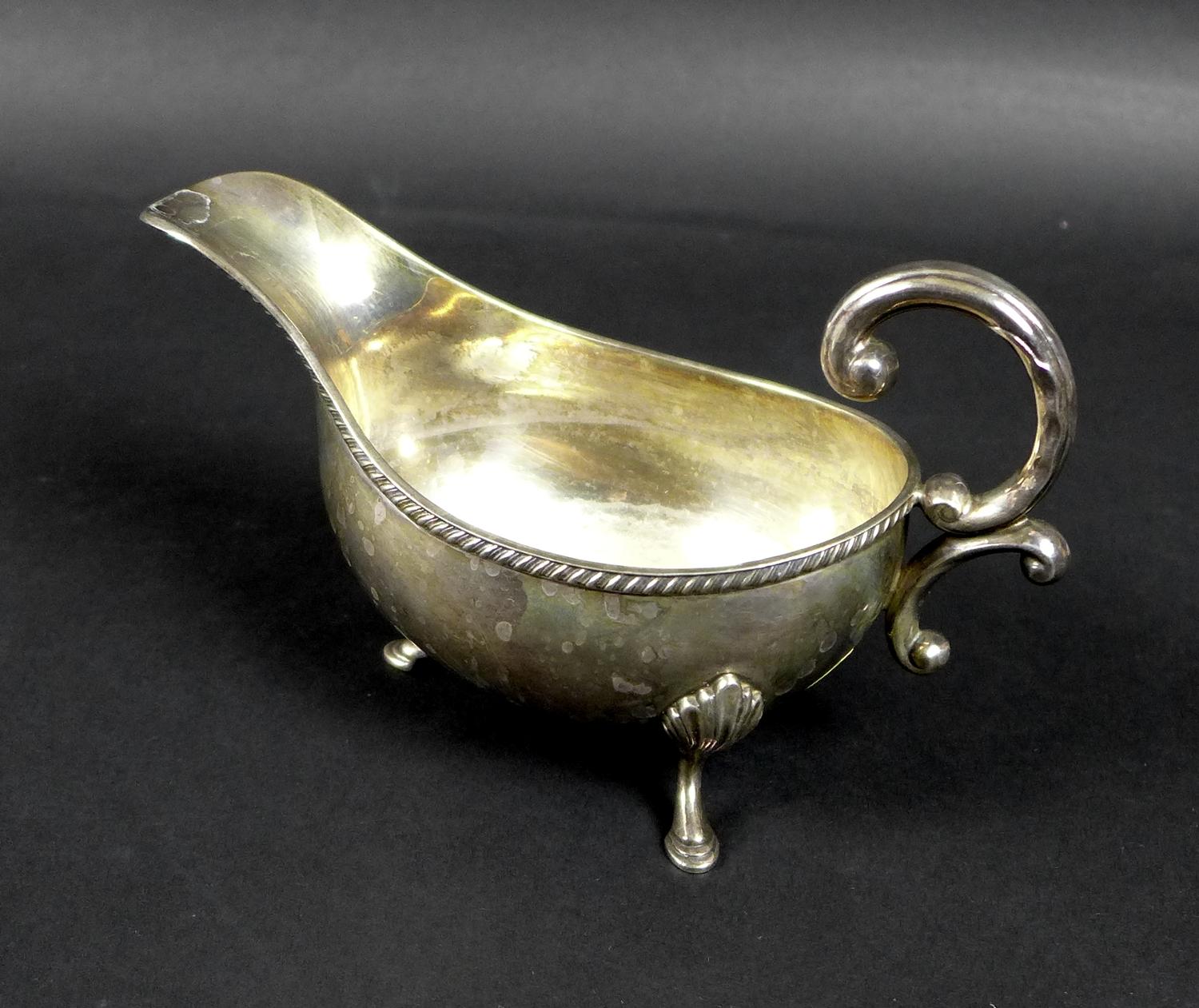 An Irish Elizabeth II silver sauce boat, with C scroll handle and gadrooned rim, raised on three - Image 3 of 6