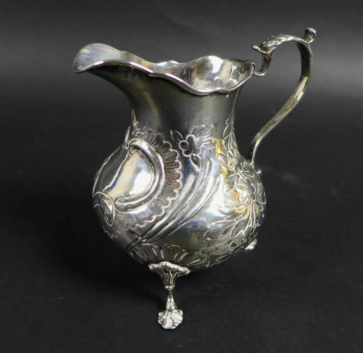 A group of five silver items, comprising a Victorian milk jug with repousse decoration and C - Image 2 of 14