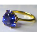 An 18ct gold and AAA tanzanite ring, the deep violet trilliant cut stone of approximately 3.3ct,