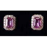 A pair of 18ct white gold, pink sapphire and diamond ear stud earrings, each set with a central
