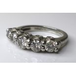 A platinum and diamond five stone designer ring, the central diamond of approximately 0.25ct,