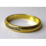 An 18ct gold and diamond ring, set with seven small brilliant cut stones, size N, 2.9g.