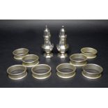 A silver salt and a silver pepper pot together with eight napkin rings, Birmingham 1991, with