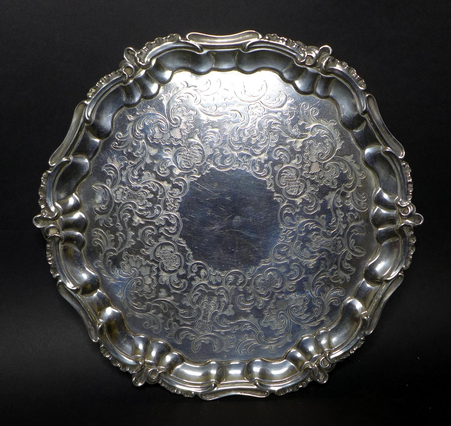 A Victorian silver salver tray, of circular Rococo form with Chippendale pie crust and C scroll rim,