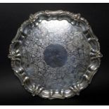 A Victorian silver salver tray, of circular Rococo form with Chippendale pie crust and C scroll rim,