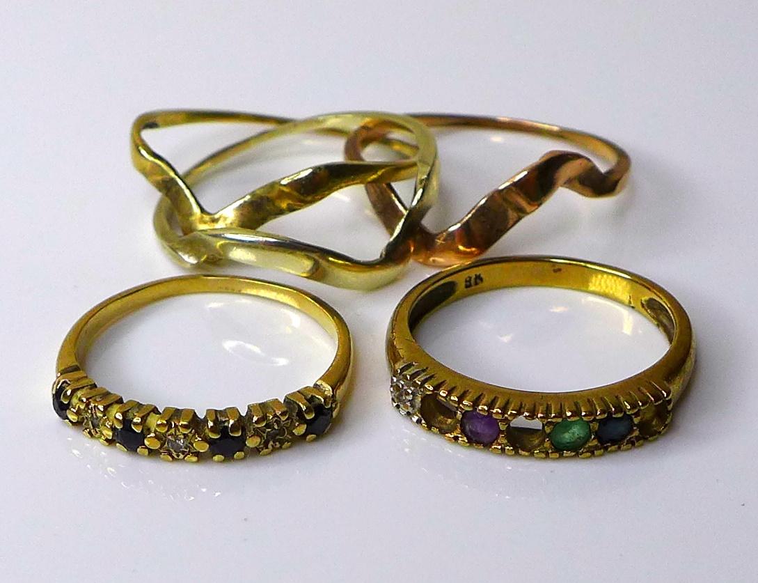 A group of three 9ct gold rings, comprising a Russian tri-gold wedding ring, a diamond and