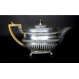 A Georgian silver teapot, with horn handle, ebony finial, with armorial engraving, gadrooning to its