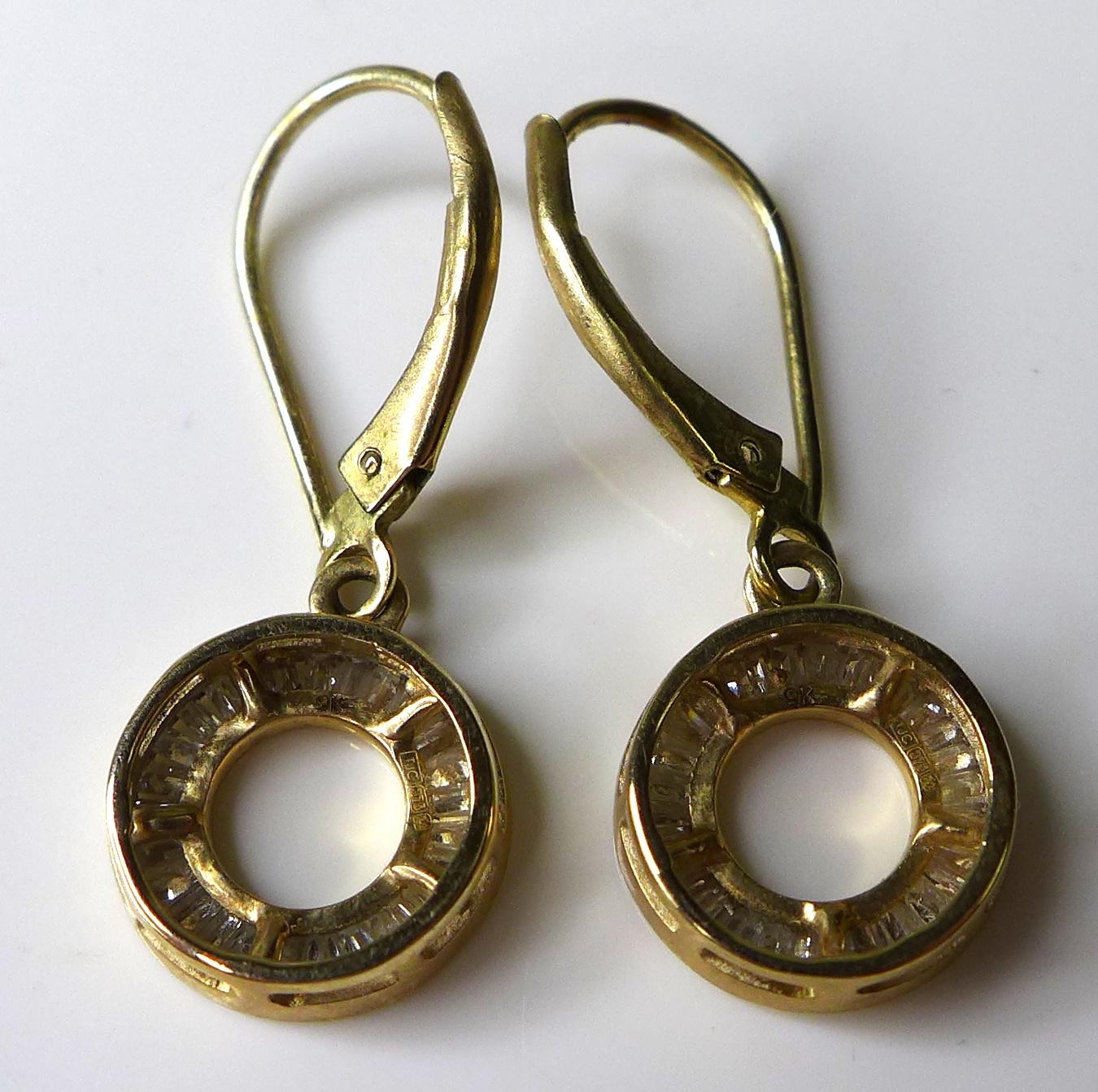 A pair of 9ct gold and diamond drop earrings of ring design, each set with approximately 24 baguette - Image 3 of 4