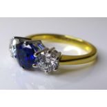 An 18ct gold, diamond and sapphire three stone ring, with central sapphire of approximately 1.2ct,