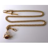 A 19th century 9ct gold Albert chain with three sided swivel fob, featuring a carnelian, onyx and