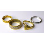 A group of four rings, comprising a platinum wedding band, size N, 3.8g, an 18ct white and yellow