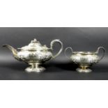 A Regency George IV silver teapot and twin handled sugar bowl, of compressed ovoid form raised on