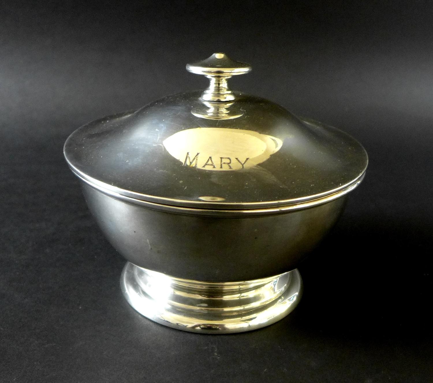 A George V silver circular lidded bowl, with 'MARY' engraved upon its lid, raised upon a circular