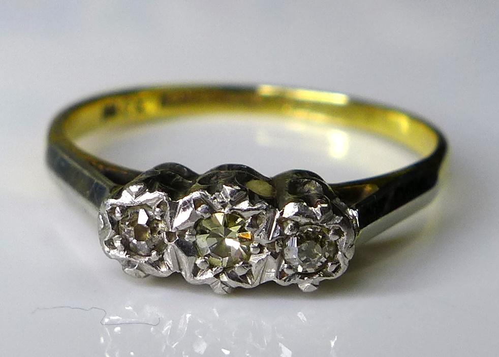 An 18ct gold and platinum three stone diamond ring, illusion set, central stone 0.1ct, size N, 2.3g. - Image 2 of 4