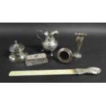 A group of five silver items, comprising a Victorian milk jug with repousse decoration and C