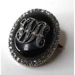 A mid 19th century mourning brooch set with diamonds, the original central jet oval with initials '