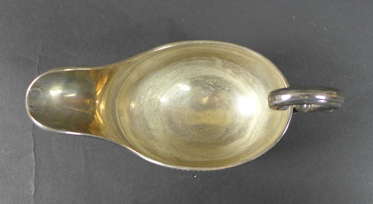 An Irish Elizabeth II silver sauce boat, with C scroll handle and gadrooned rim, raised on three - Image 4 of 6