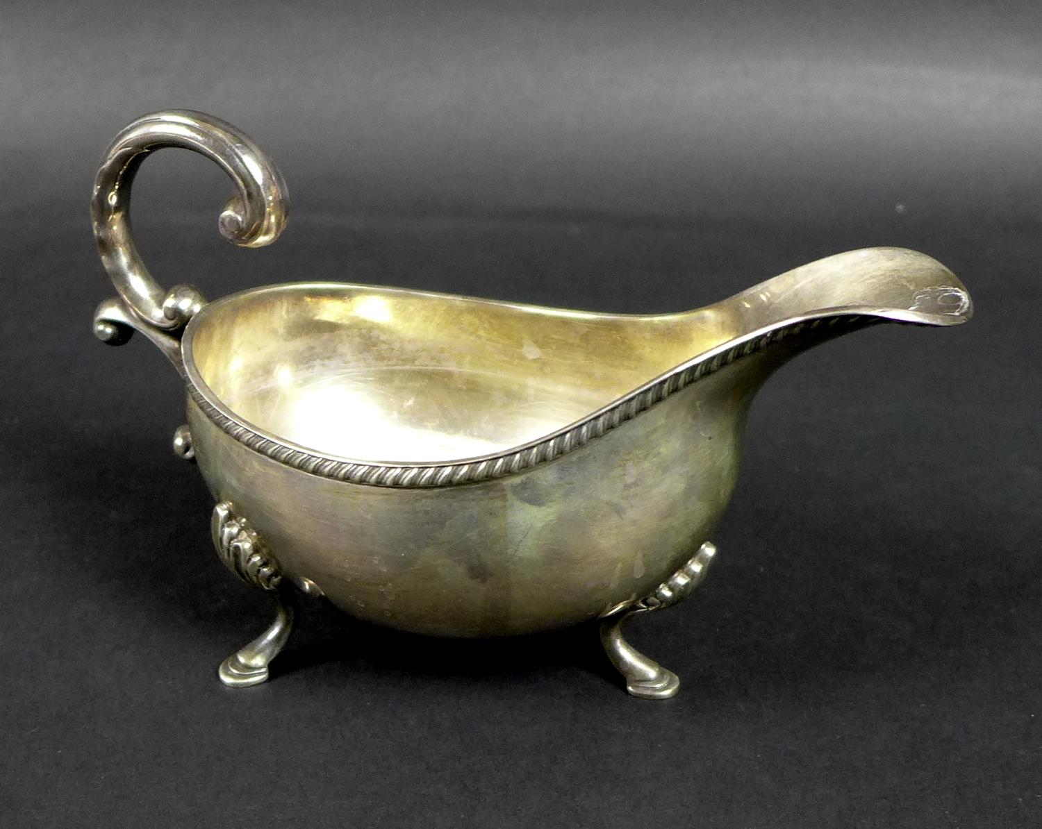 An Irish Elizabeth II silver sauce boat, with C scroll handle and gadrooned rim, raised on three - Image 2 of 6