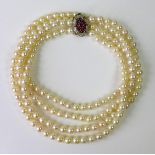 A two strand pearl necklace with 9ct gold ruby and diamond clasp, the pearls approximately 5mm