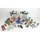 A group of nine 1980s Transformers toy action figures, including Hot-Rod, two Metroplex figures, and