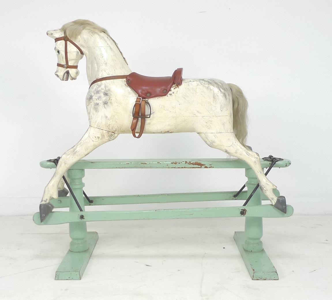 An Edwardian G & J Lines extra carved rocking horse, painted dapple grey horse with brown leather